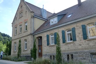 Außenansicht der alten Schule mit Natursteinen