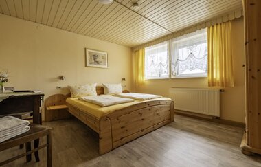 Rustikales Doppelbett und Tisch mit Stuhl